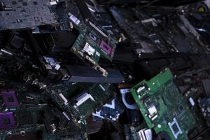 a pile of computer parts, motherboards, circuit boards, cooling fan, and more